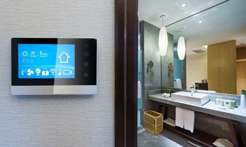 Modern bathroom featuring digital control panel and sink, showcasing plumbing technology by Charles Krull & Son, Inc.
