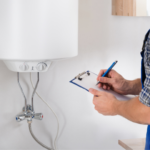 Technician inspecting a wall-mounted water heater, clipboard in hand, for boiler maintenance before winter.