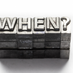 3D metallic blocks spelling 'WHEN#039; on an industrial background, representing HVAC inquiries from Charles Krull & Son.